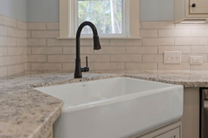 ferguson kitchen faucet with corner farm sink and counter in custom home