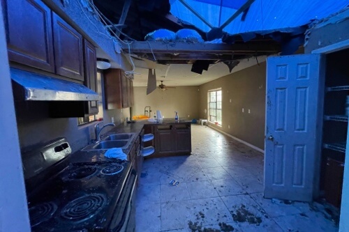 Image of inside kitchen that had damage to roof due to fallen tree during hurricane Ida