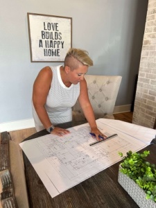 What Sets Us Apart from Other Custom Home Builders? | eNg Designs & Construction. eNg owner Erika Hemphil doing house plans in the office.